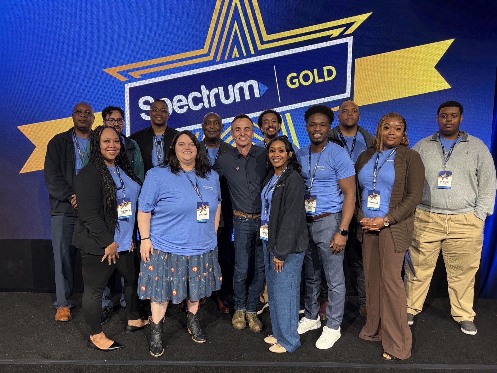 Keni Thomas with the Spectrum team on stage
